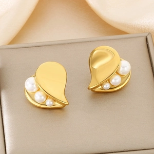 French style gold heart asymmetric earrings with pearls on a golden satin background