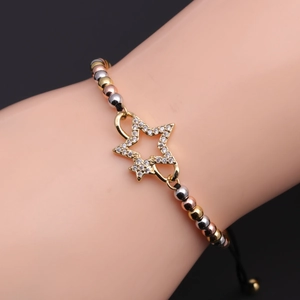Detail of adjustable star charm bracelet with gold silver and rose gold beads