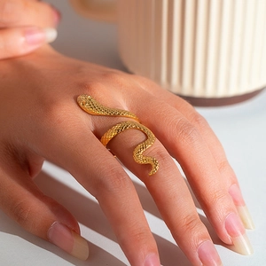 Detailed close-up of a gold snake-shaped ring showing intricate scale textures and spiral design