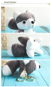 Macro details of mini husky plush keychain with grey white fur and gold metal clasp