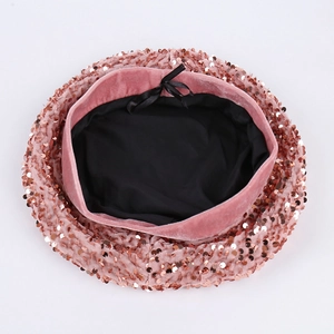 Pink sequin beret with sparkling round details and velvet trim on a white background