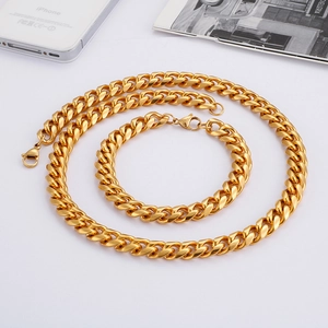 Close-up of golden stainless steel Cuban link chain necklace and bracelet jewelry set