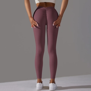 Close-up of the scrunch butt detail and high-waist fit on these dark purple yoga pants