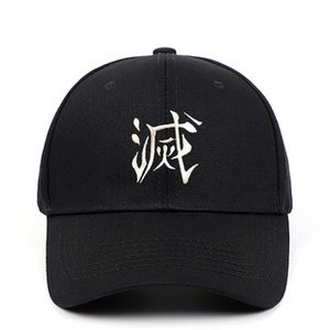 Detail shot of white embroidery on a black vintage baseball cap with distressed finish