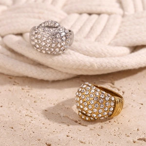 Detail of gold and silver plated stainless steel rings with sparkling cubic zirconia pavé