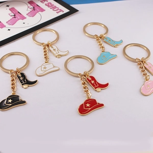 Detail of colorful enamel cowboy hat and boot keychains in five vibrant shades