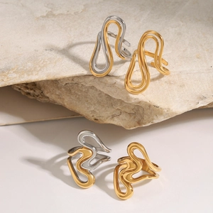 Artistic gold wave stainless steel open rings displayed on natural stone texture