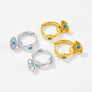 Detailed close-up of S925 sterling silver evil eye earrings with blue zircon in gold and silver