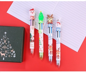 Close-up of multi-color Christmas ballpoint pens with Santa and reindeer cartoon toppers