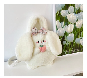Detailed view of white plush bunny backpack with pink peach and checkered bow detail