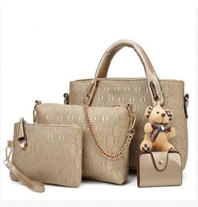 Golden 4-piece handbag set for women with embossed pattern and cute bear charm