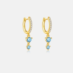 Detail view of S925 sterling silver gold earrings with blue gemstones and white zircons