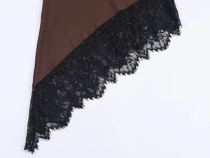Detail shot of the dark brown satin dress hem with intricate black lace trim edges