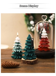 Detailed close-up of handmade Christmas tree candles with pine needle texture and glass dome