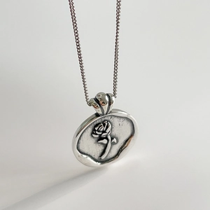 Vintage 925 sterling silver necklace with embossed rose coin pendant and curb chain