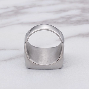 Macro detail of silver stainless steel Masonic ring with crystals on marble background