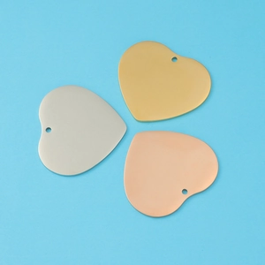 Polished 33mm heart pendants in gold, silver and rose gold on a blue background