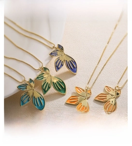 Set of five colorful leaf pendant necklaces with gold finish and enamel texture details