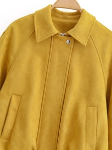 Detail of ginger yellow suede jacket with notched lapel and silver metal zipper