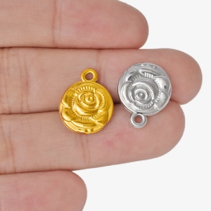 304 stainless steel rose flower pendants in gold and silver finish shown on a finger