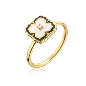 Macro detail of 18K gold rotating clover ring with black and white zircon petals