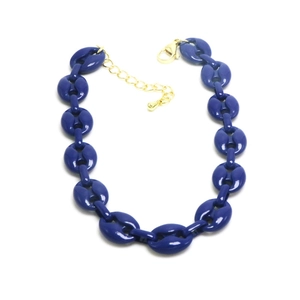 Macro detail of glossy dark blue coffee bean link chain with a golden lobster clasp