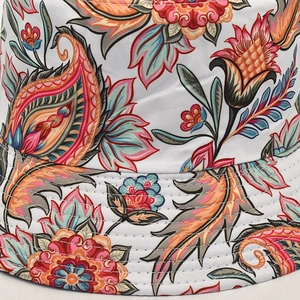 Macro shot of high-quality stitching and vibrant paisley floral print on a bucket hat