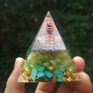 Detailed macro of handmade orgone pyramid with amethyst sphere and copper coil layers