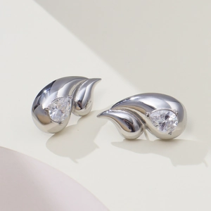 Macro view of teardrop 18k gold-plated stainless steel earrings with sparkling zirconia