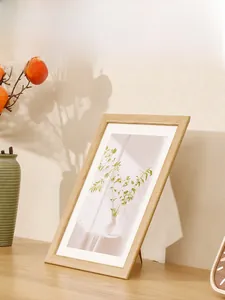 Detail of light wood grain photo frame with botanical art and a sturdy back stand