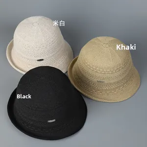 Overhead view of breathable woven bucket hats in off-white, khaki, and black colors