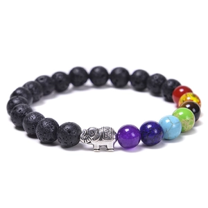 Close-up of elephant pendant on black lava and seven chakra stone beaded elastic bracelet