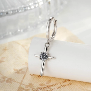 Silver cross earring with black round stone shown in detailed macro shot view
