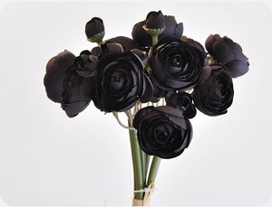 Close-up of artificial black ranunculus bouquet with silk petals and green stems