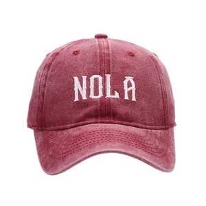 Vintage burgundy baseball cap with white NOLA embroidery on a clean white background