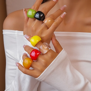Close-up of vibrant multi-color thick resin rings worn together for a trendy bold style