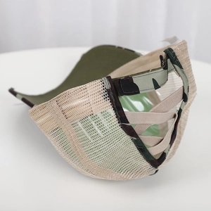 Detail of army green camo baseball cap with criss-cross elastic ponytail back and mesh