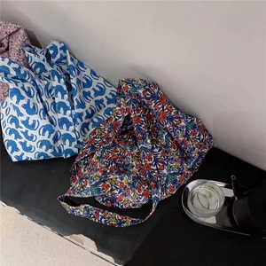 Close-up of floral and animal print cotton tote bags with soft fabric texture details