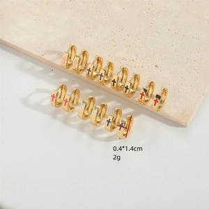 Set of minimalist gold hoop earrings featuring colorful cross designs in various shades