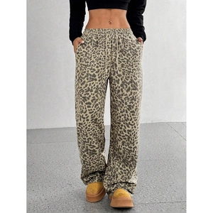 Detail showing high-waisted leopard print wide-leg trousers with drawstring and side pocket