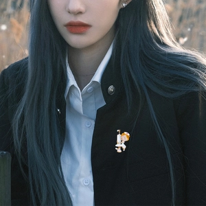 Detail of cartoon nurse brooch with red cross on a black blazer lapel for medical staff