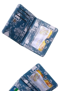 Detail of navy blue skull print wallet showing interior card slots and ID window