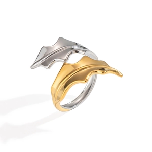 Close-up of artistic spiral seaweed ring in gold and silver finish with open band