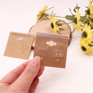 Kraft paper earring display card with hanging hook and clear plastic self-sealing bag