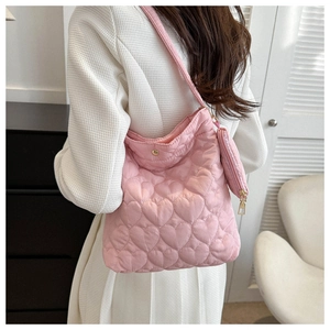 Detail of pink quilted heart pattern tote bag with matching small coin purse pendant