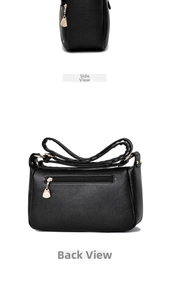 Detail view of black lychee leather bag showing side profile and back zipper pocket