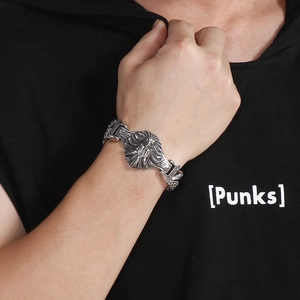 Close-up of retro 304 stainless steel wolf head bracelet on male wrist for punk style