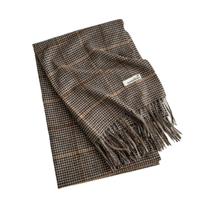 Houndstooth pattern cashmere scarf with orange accents and twisted tassels on white background