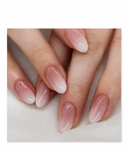Detailed macro view of nude-white gradient press-on nails with subtle shimmer finish