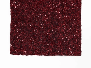Close-up of deep red sequin fabric detailing high-density shine on a V-neck dress